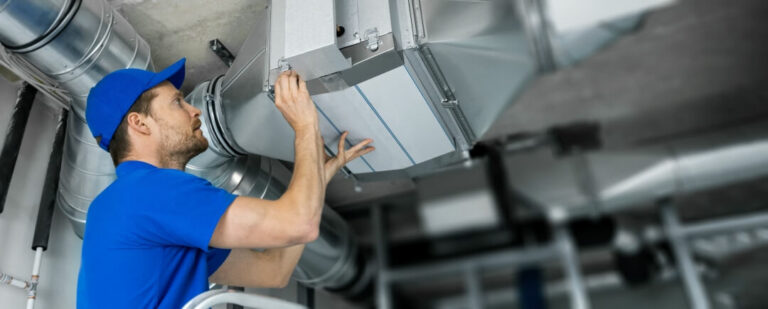 HVAC technician performing maintenance on rooftop air handling unit