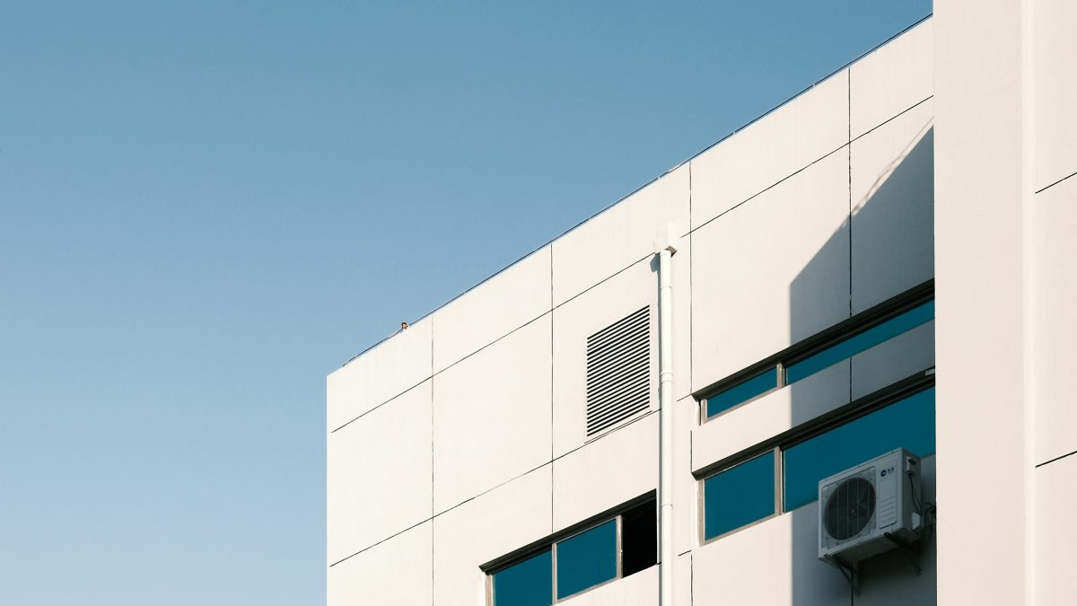 An air conditioning unit mounted on the outside of an office building