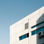 An air conditioning unit mounted on the outside of an office building