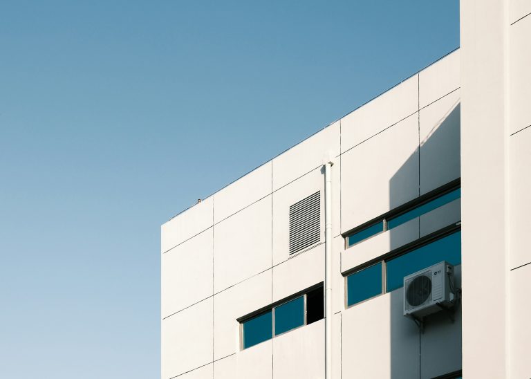 An air conditioning unit mounted on the outside of an office building